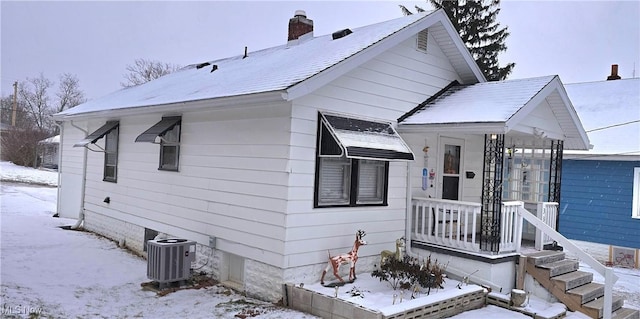 bungalow featuring central AC and a chimney