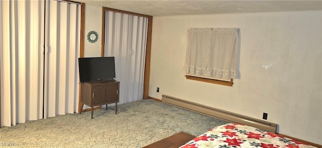 bedroom featuring a textured ceiling, carpet floors, and baseboard heating