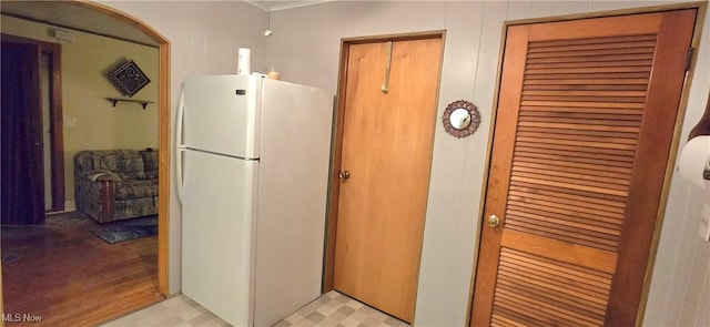 kitchen featuring light floors and freestanding refrigerator