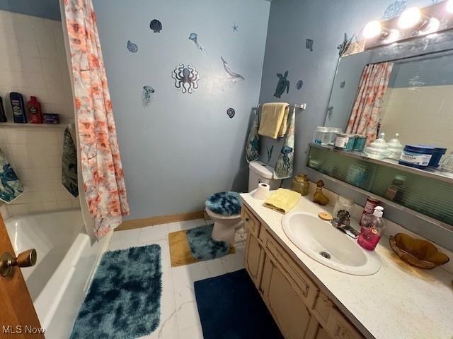 bathroom with shower / bathtub combination with curtain, toilet, vanity, tile patterned flooring, and baseboards