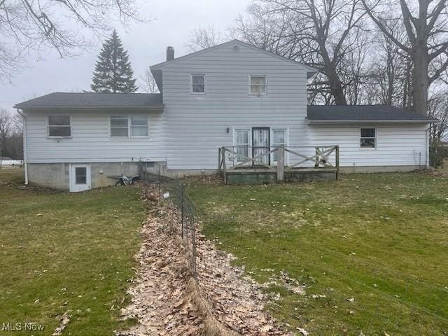 3335 N Maple Ln, Ashtabula, OH 44004 - back of property with a lawn, a chimney, and a wooden deck