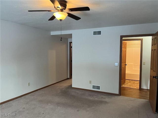 unfurnished bedroom with carpet floors, baseboards, and visible vents