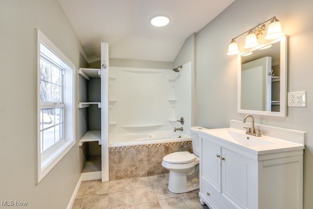 full bathroom with tiled shower / bath, toilet, vaulted ceiling, vanity, and tile patterned floors