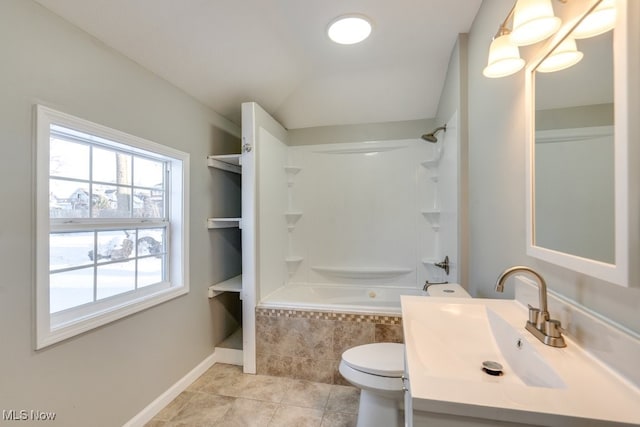 full bathroom featuring baseboards, toilet, tile patterned floors, tiled shower / bath, and vanity