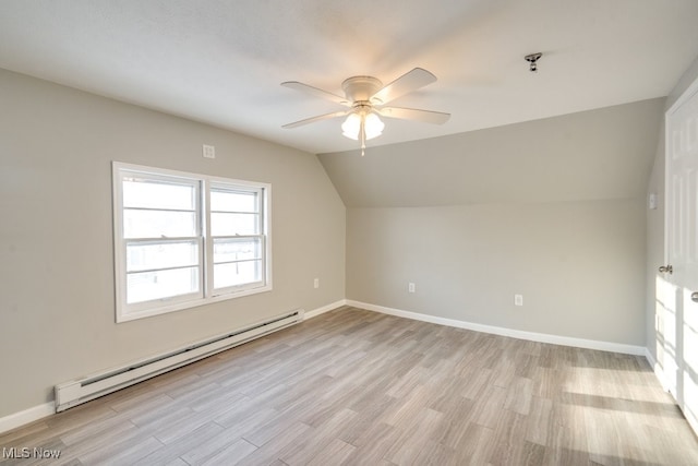 additional living space with light wood finished floors, baseboards, lofted ceiling, a baseboard radiator, and ceiling fan