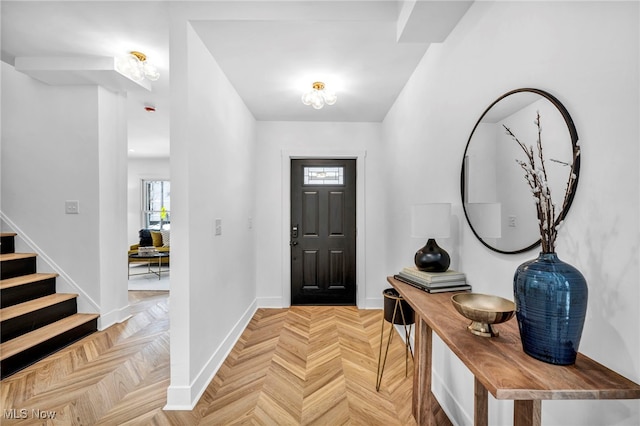 entryway with stairway and baseboards