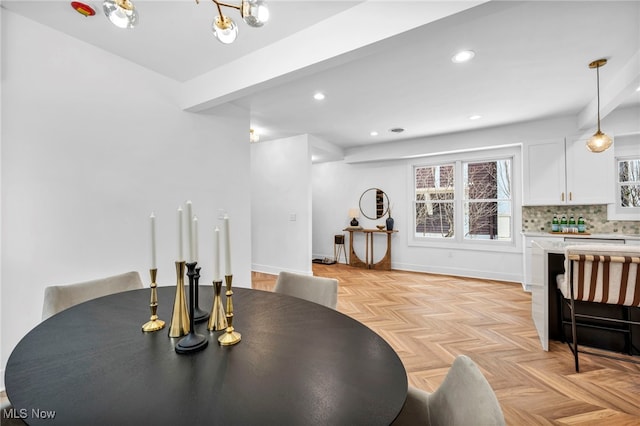 dining room featuring baseboards and recessed lighting