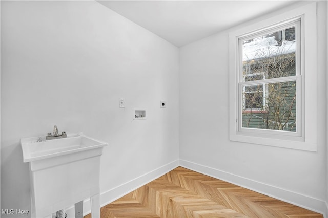 washroom featuring washer hookup, a sink, electric dryer hookup, laundry area, and baseboards