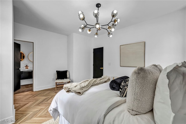 bedroom with a notable chandelier and baseboards