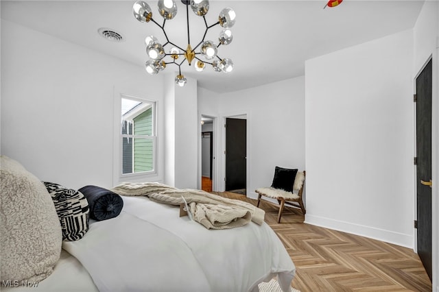 bedroom featuring baseboards, visible vents, and a notable chandelier