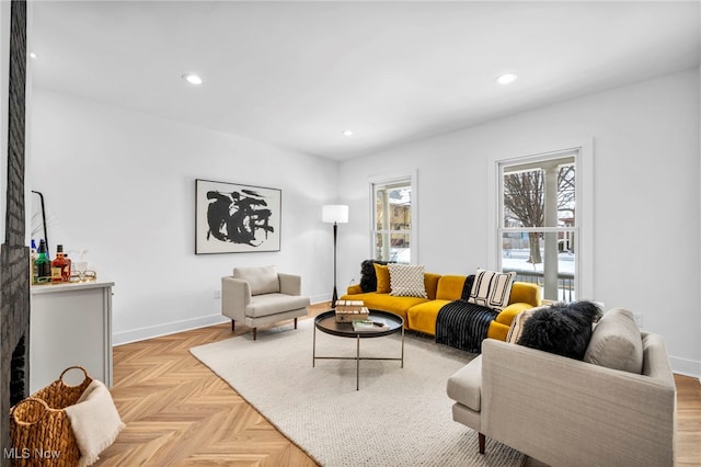 living area featuring recessed lighting, a fireplace, and baseboards