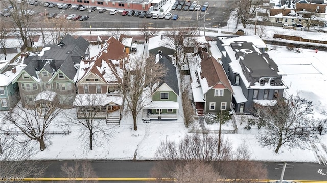 snowy aerial view with a residential view