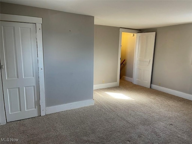 empty room with carpet floors and baseboards