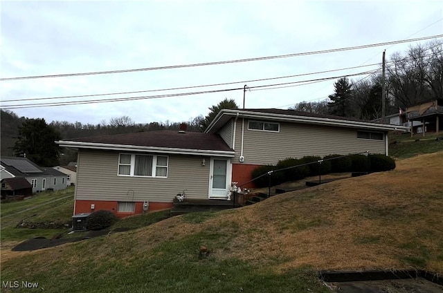 rear view of house with a yard