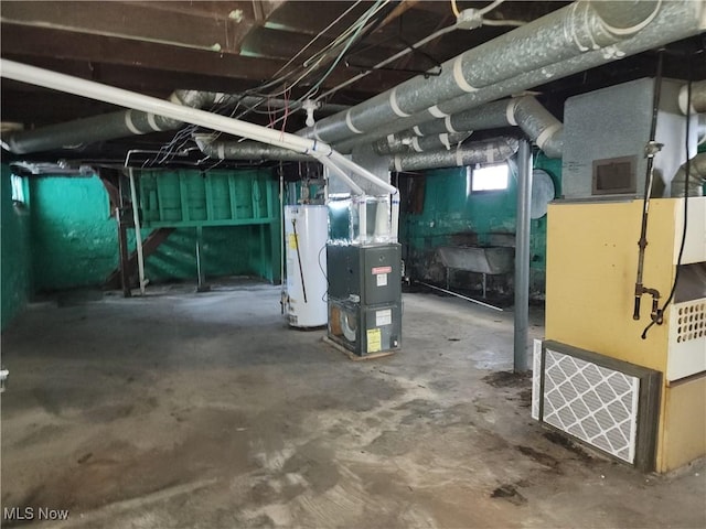 basement featuring water heater and heating unit