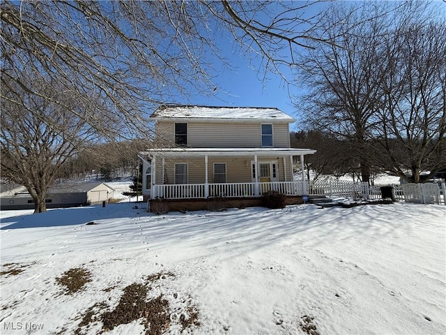 view of front of home featuring fence and a porch