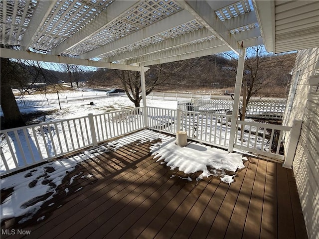 snow covered deck featuring a pergola