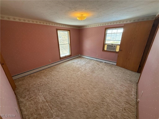 spare room with a textured ceiling, cooling unit, and carpet flooring