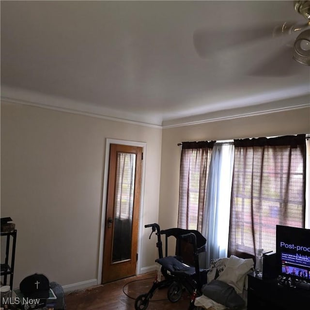 interior space featuring plenty of natural light, ornamental molding, and baseboards