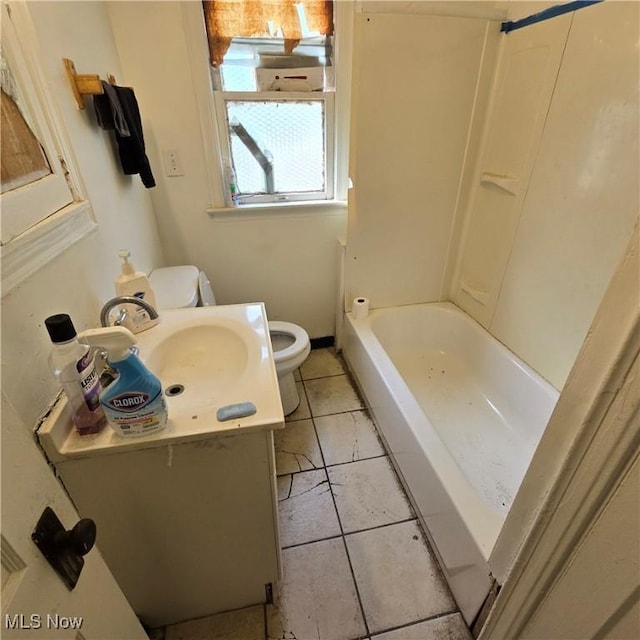 bathroom featuring a tub to relax in, tile patterned flooring, vanity, and toilet