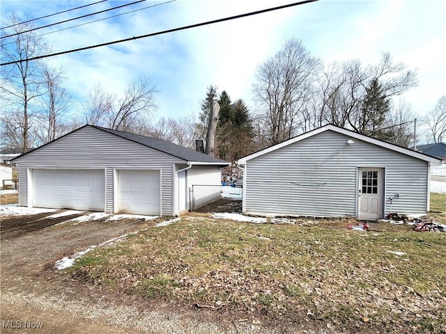 detached garage featuring fence