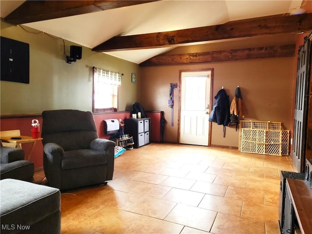 living area featuring vaulted ceiling with beams