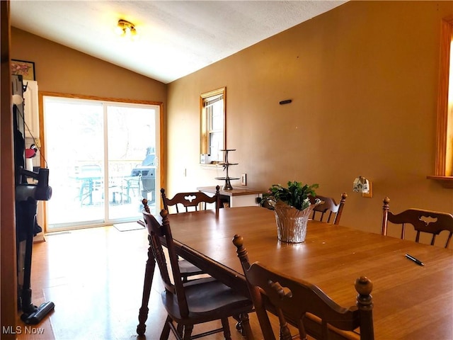 dining room with vaulted ceiling