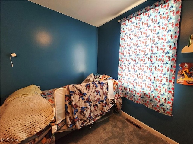 bedroom with carpet, visible vents, and baseboards