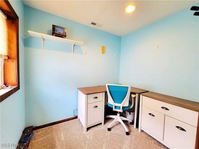 office area with baseboards, visible vents, and light colored carpet