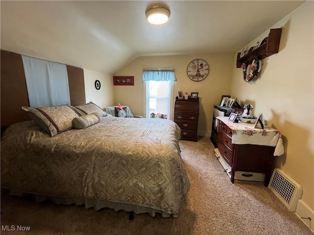 carpeted bedroom featuring vaulted ceiling, visible vents, and baseboards