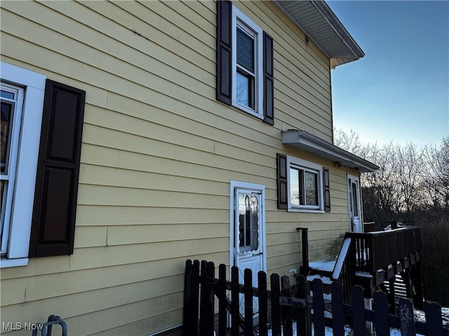 view of side of property featuring fence