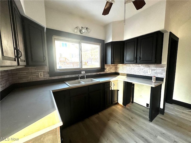 1519 Saint Clair Ave, East Liverpool, OH 43920 - kitchen with a ceiling fan, light wood finished floors, decorative backsplash, dark cabinets, and light countertops