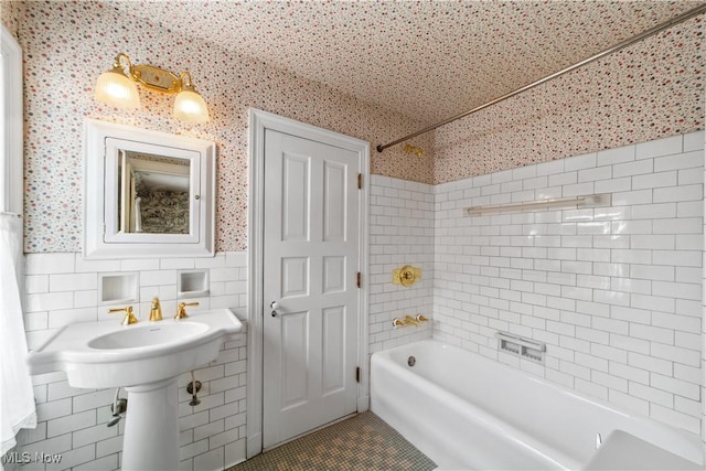 full bathroom featuring wallpapered walls, wainscoting, tile patterned floors, shower / washtub combination, and tile walls