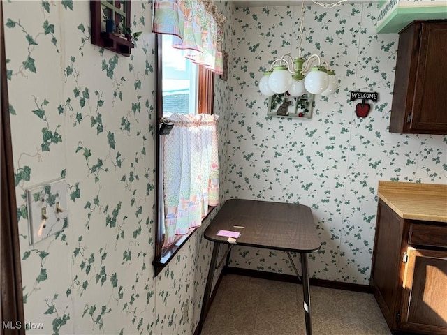 bathroom with wallpapered walls and baseboards