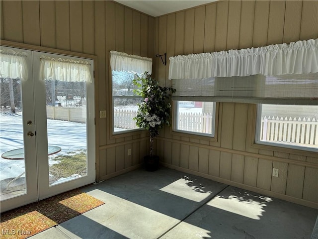 unfurnished sunroom with a wealth of natural light and french doors