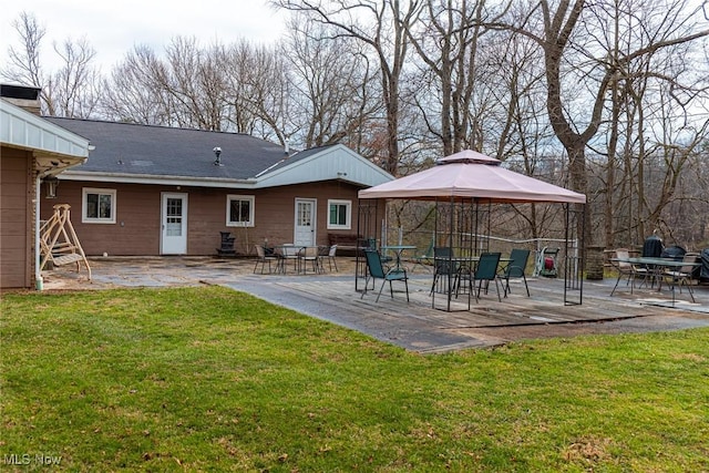 back of house featuring a yard, a patio, and a gazebo