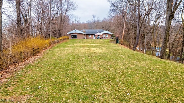 view of yard with a view of trees