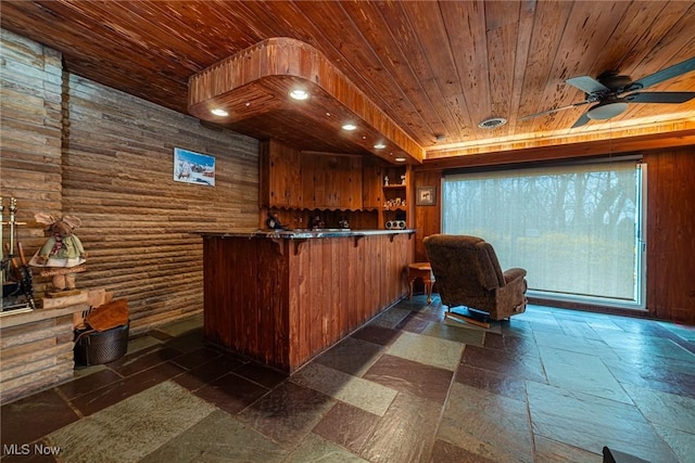 bar with stone tile floors, recessed lighting, a ceiling fan, wooden walls, and wooden ceiling