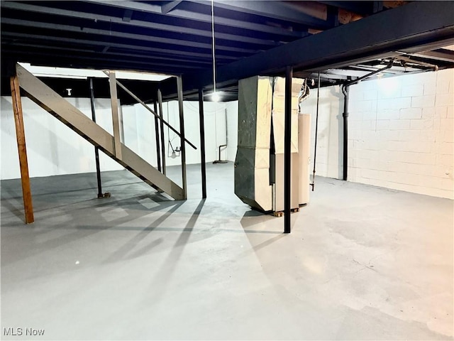 unfinished basement featuring heating unit and gas water heater