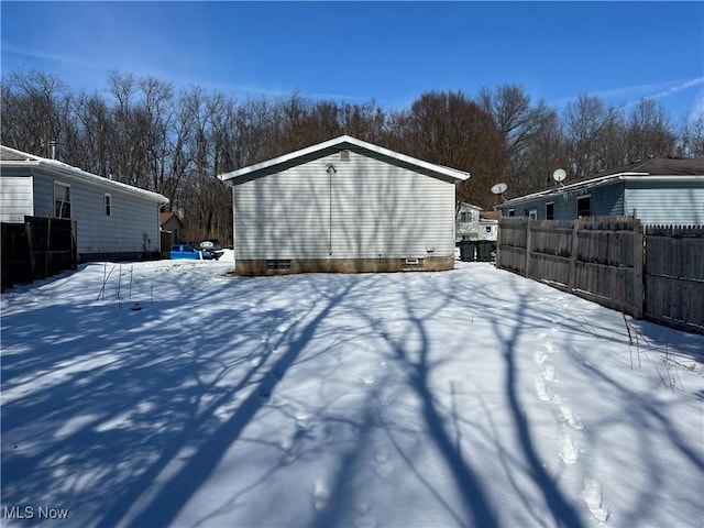 yard layered in snow with fence