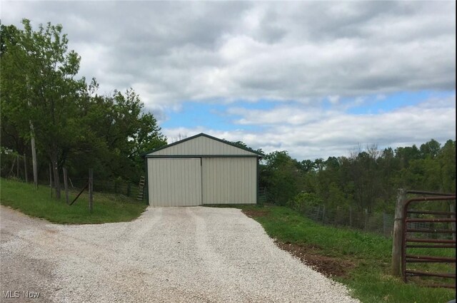 view of pole building with fence