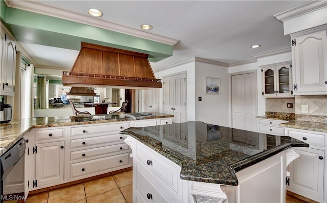 kitchen featuring a center island, crown molding, glass insert cabinets, white cabinetry, and black appliances