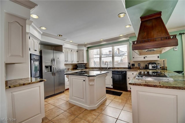 kitchen with island range hood, a center island, stainless steel appliances, white cabinetry, and a sink