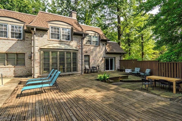 deck featuring outdoor dining space and fence