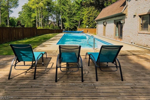 view of swimming pool featuring a fenced in pool, a fenced backyard, and a deck