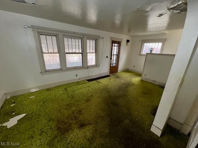 interior space with carpet floors and baseboards