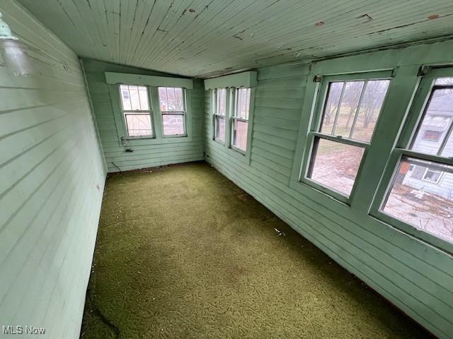 unfurnished sunroom with wooden ceiling