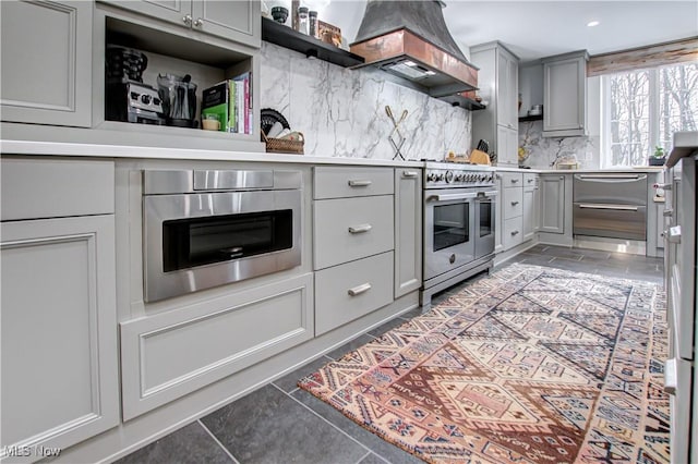 kitchen featuring custom range hood, open shelves, light countertops, and gray cabinetry