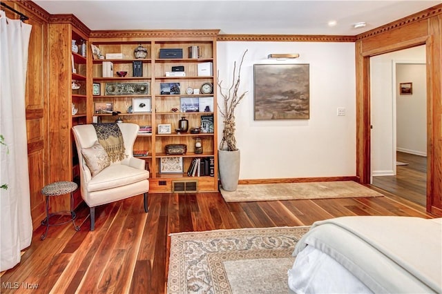 living area featuring dark wood finished floors, visible vents, and baseboards