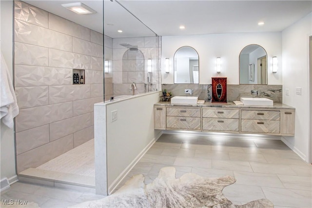 full bathroom with walk in shower, a sink, decorative backsplash, and double vanity